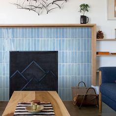 a living room with a blue couch and fireplace