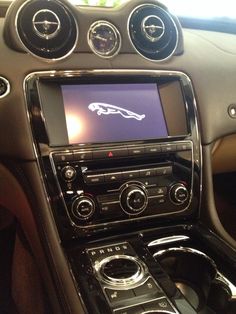 the interior of a car with an image of a jaguar on it's screen