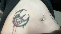 a person with a tattoo on their stomach has blood dripping down the side of her belly