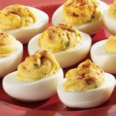 deviled eggs are arranged on a red plate