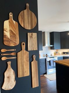 wooden cutting boards mounted to the side of a black wall