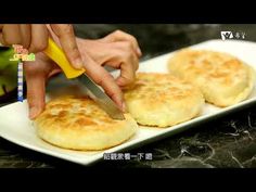 a person cutting up some food on a white plate with a yellow knife in front of them