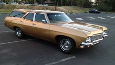 a tan station wagon parked in a parking lot