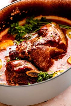 a pot filled with meat and vegetables on top of a table