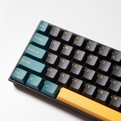 a black and yellow computer keyboard on a white surface with the keys highlighted in gold