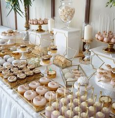 a table topped with lots of donuts and cupcakes