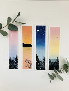 three watercolor bookmarks with trees and the moon in the sky on one side