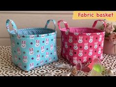 two baskets with bunny ears on them sitting next to each other