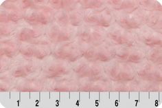 a ruler is shown with pink yarn on it