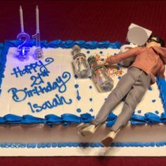 a birthday cake with a doll laying on it