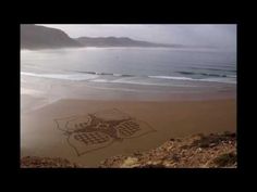 a drawing on the beach with waves in the background