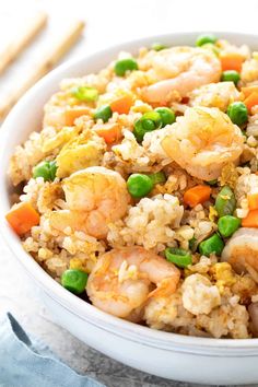 shrimp and rice with peas in a white bowl