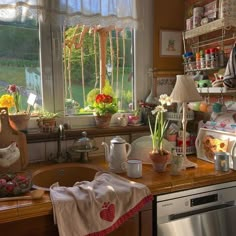 a kitchen filled with lots of pots and pans next to a sink under a window