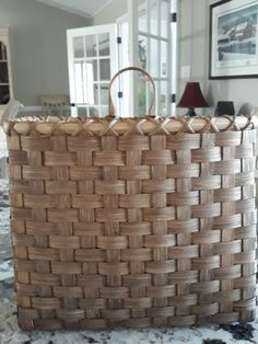 a large woven basket sitting on top of a table