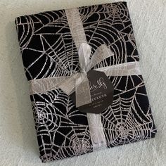 a gift wrapped in black and white fabric