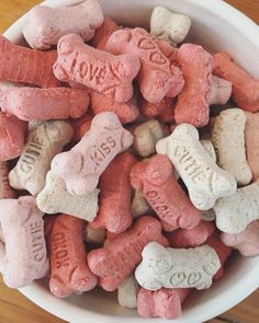 a bowl filled with pink and white dog treats