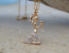 "Beautiful mermaid holding a heart and a dangling CZ charm on a gold filled delicate chain. The charm and necklace are both 18K gold filled (not gold plated), which will not tarnish. There are micro pave CZ's on the mermaid tail. This is such a stunning necklace for that mermaid at heart! Necklace measures approximately 16\", the charm is 1 1/4\". I can make the necklace chain longer or shorter, please convo me." Mermaid Charm Necklace With Lobster Clasp For Gift, Chic Bedrooms, Flamingo Jewelry, Mermaid Vibes, Gold Mermaid, Mermaid Pendant, Chalcedony Earrings, Beach Earrings, Mermaid Jewelry