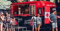 people standing in line to order food from a truck