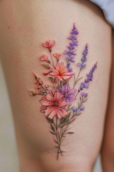 a woman's thigh with flowers painted on it