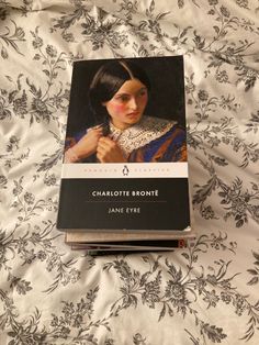 the book charlotte brontee by jane eyel is on top of a bed