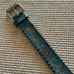 Beautiful! Never Worn! Nwot Large Teal Belt With Engraved Floral Design. Silver Buckle. Colors: Teal, Orange, Yellow, Brown, Red. Measures About 40” Including 1.5” Buckle X 1.5”. Holes Are Located From 31.5” To 35.5”. From Smoke Free Dog Friendly Home. Teal Belt, Floral Belt, Teal Orange, Free Dogs, Design Silver, Dog Friendly, Orange Yellow, Dog Friends, Blue And Silver