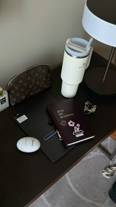 a desk with a book, mouse and other items on it