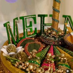 there is a cake decorated with beads and decorations on the top layer that says welcome