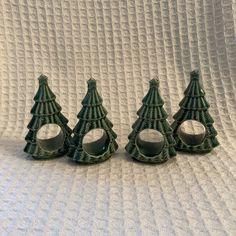 three small green christmas trees sitting next to each other