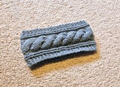 a knitted headband laying on the floor