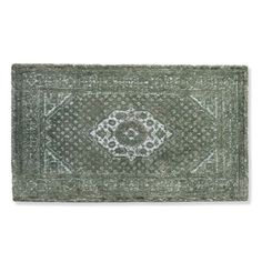 a green rug with an intricate design on the front and back side, in grey tones