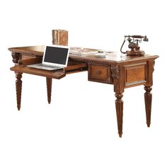 an old fashioned desk with a laptop on it