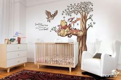 winnie the pooh wall decal in a baby's room with a crib