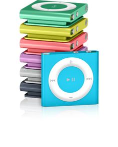 an ipod sitting on top of each other in front of a stack of colorful books