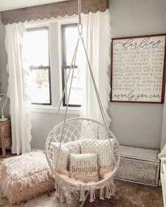 a bedroom with a swing chair and window