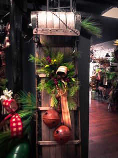 an old wooden ladder decorated with christmas wreaths and bells