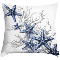 three blue starfishs on a white pillow