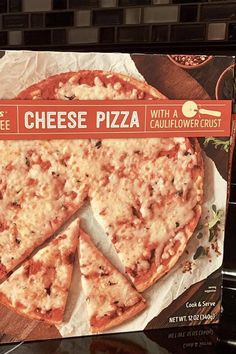 a box of cheese pizza sitting on top of a counter