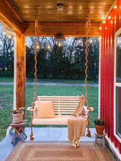 a porch swing with lights hanging from it