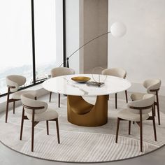 a round table with chairs around it in front of a large window and floor to ceiling windows