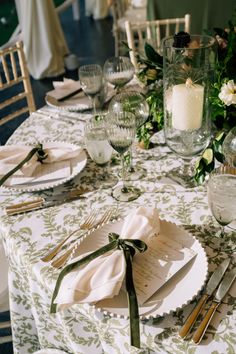 the table is set with place settings for dinner