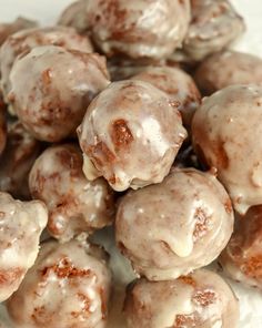 a pile of doughnuts sitting on top of a white plate covered in icing