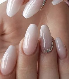 a woman's hand with some pink and white nails