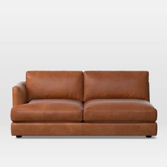 a brown leather couch against a white background