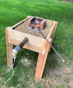 an outdoor fire pit made out of pallet wood with a hose connected to it