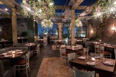 an empty restaurant with tables and chairs set up for dinner at the end of the room