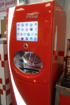 an old fashioned coca cola machine in a kitchen