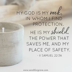 a white candle sitting on top of a table next to a quote that says, my god is my role in whom i find protection