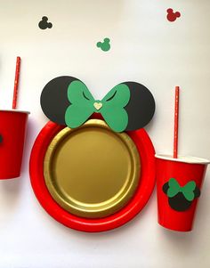 mickey mouse plates and cups on a table