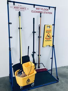 a cleaning station with mop buckets and brooms