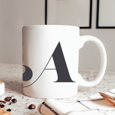 a white coffee mug sitting on top of a table